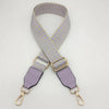 A light purple and gray braided nylon strap for a bag, featuring gold-toned metal hooks.