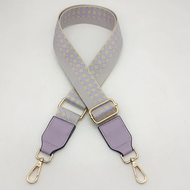 A light purple and gray braided nylon strap for a bag, featuring gold-toned metal hooks.