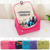 Eine Sammlung wasserfester Aufbewahrungstaschen für Make-up, in verschiedenen Farben wie rosa, blau, lila und grün.