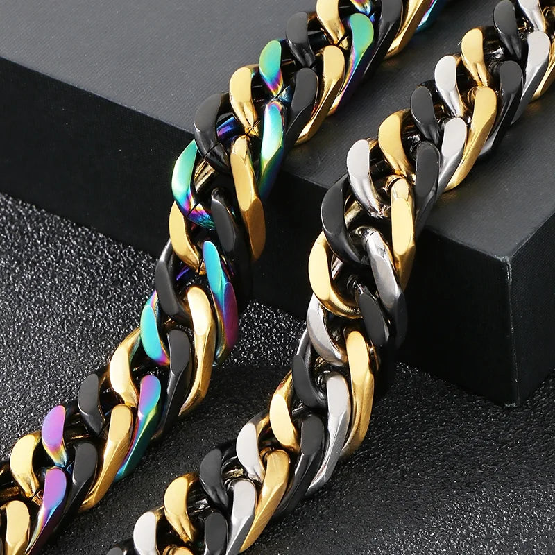 A pair of chunky gold and black Cuban link bracelets displayed on a dark surface.