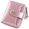 A pink leather wallet with a clasp closure and card slots, featuring a decorative gold flower button.