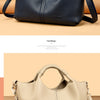 A beige luxury soft leather women's tote bag shown in a studio setting.