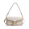 A light beige women's premium textured shoulder bag with a gold chain strap.