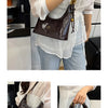 A woman holds a brown retro PU leather shoulder bag against a white blouse and light blue jeans.