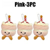 Three pink bread plush keychains with striped straws and smiling faces