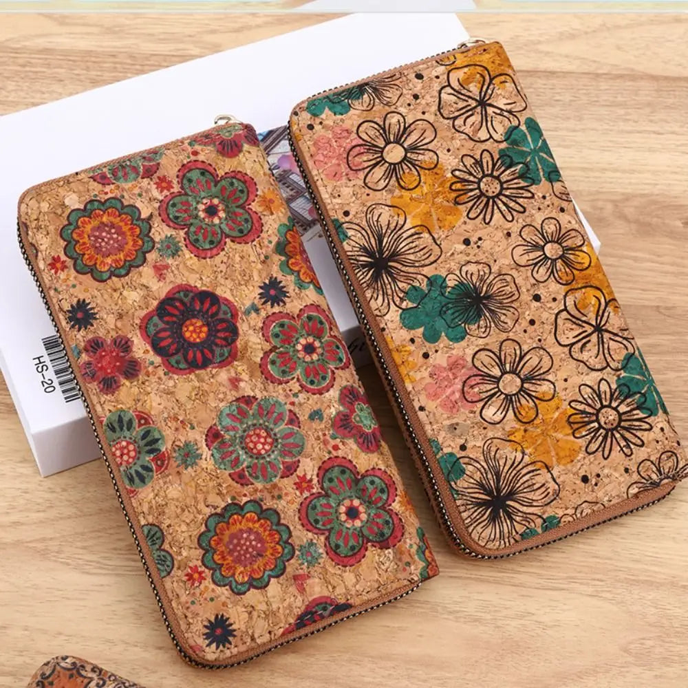 A brown wood-grain leather wallet decorated with floral patterns and used as a card holder.