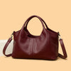 A deep burgundy leather women's casual crossbody shoulder bag with a zip closure shown against a light background.