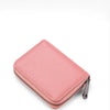 A pink classic zipper card holder wallet shown from above.