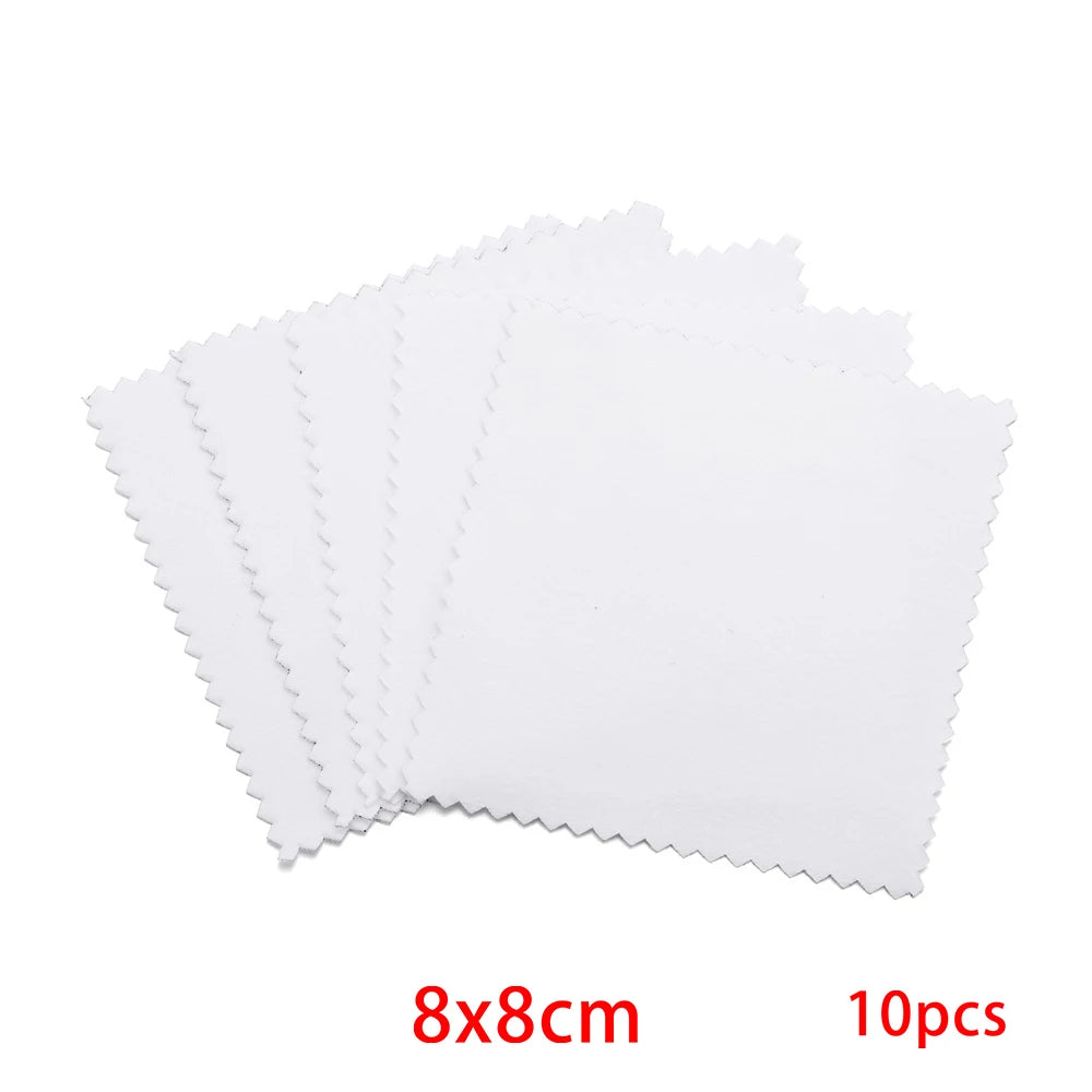 A set of ten white polishing cloths for silver and gold jewelry, shown in a stack.