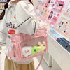 A pink transparent shoulder tote bag filled with small plush toys in a retail setting.