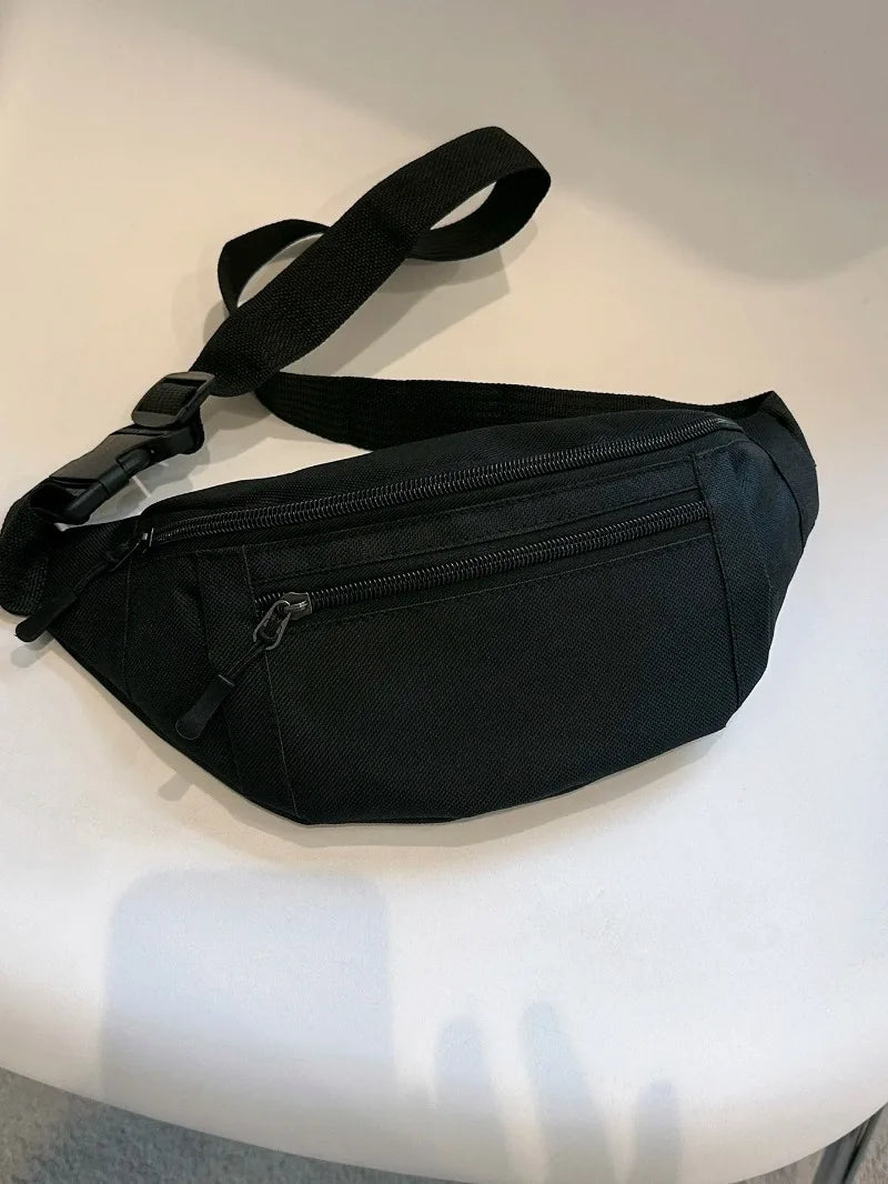 A black compact nylon waist bag with a strap is shown against a white background.