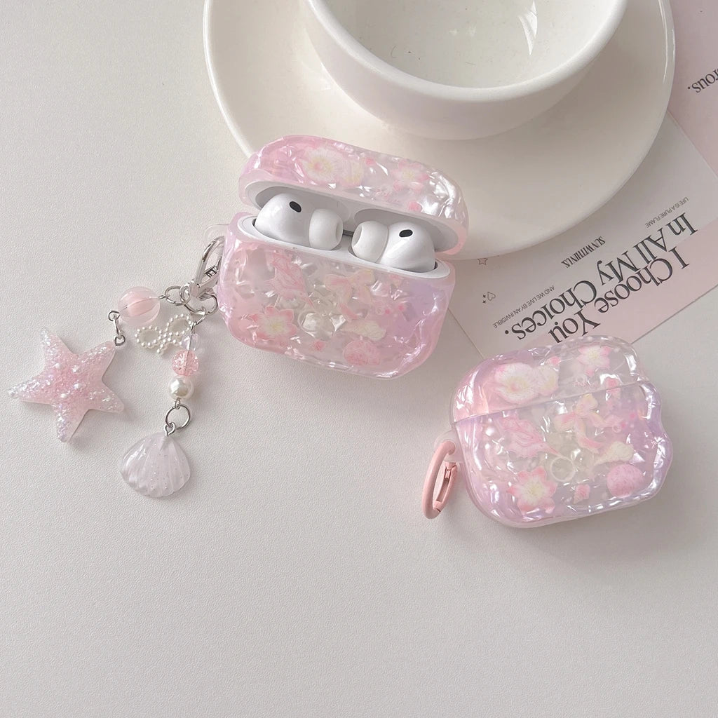 Étui d'écouteurs en nœud floral rose pour AirPods, à côté d'un bol blanc et du papier.