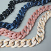 A display of acrylic resin detachable bag chain straps in shades of blue, pink, and cream.