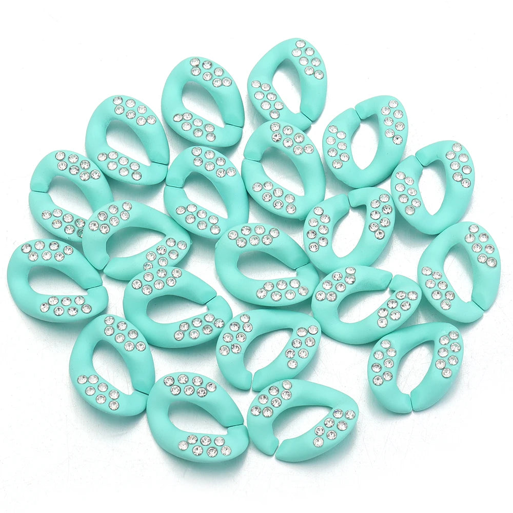 A collection of light mint green acrylic link chain connectors adorned with small clear rhinestones.