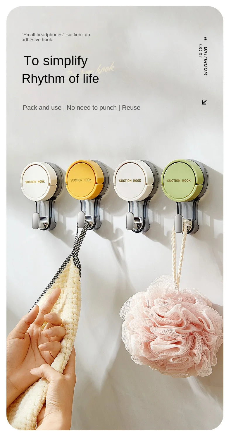 A hand is shown using a suction cup hook to hang a pink, fluffy item on a smooth surface.
