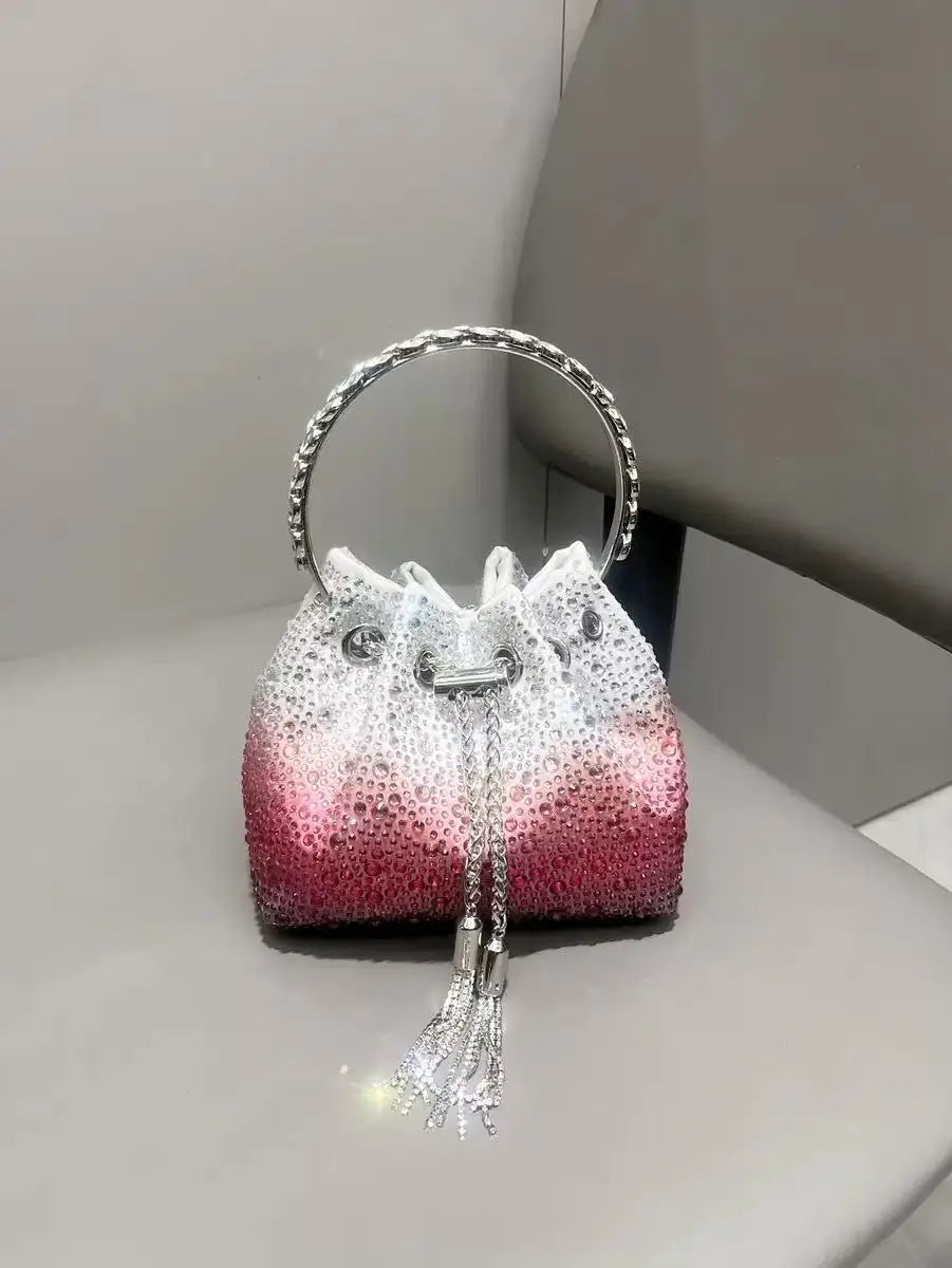 A pink and white crystal-embellished evening clutch with a silver chain and hoop.