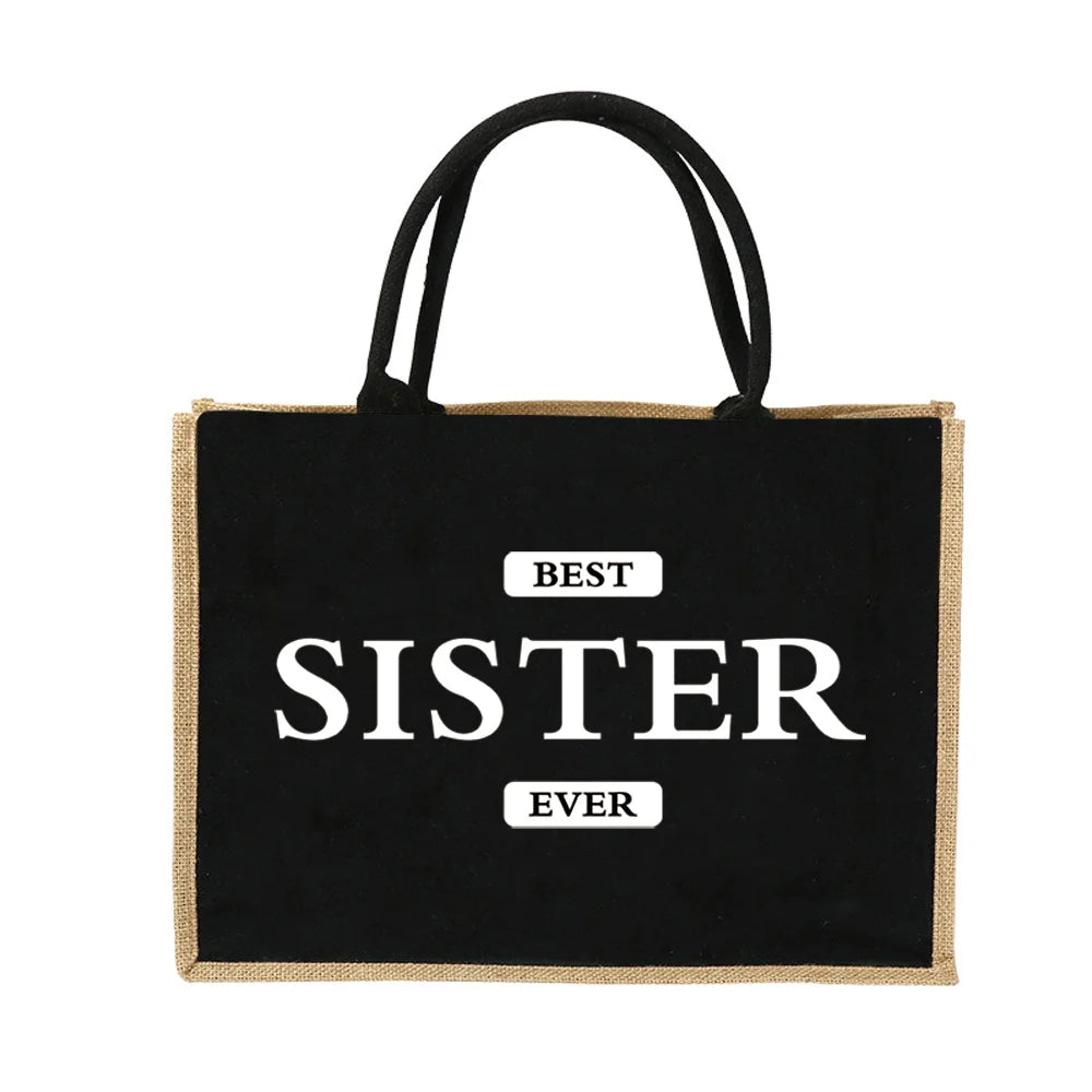 Schwarze Jute-Burlap-Tasche mit weißer Aufschrift: BESTE SCHWESTER JEGEN