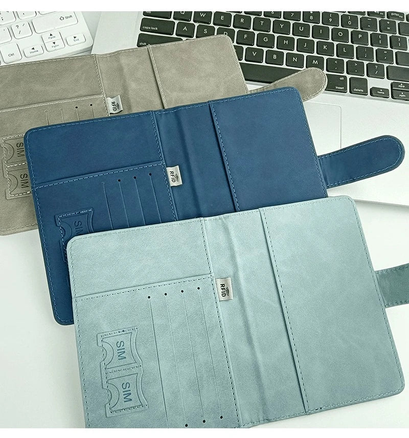 A set of three elegant RFID blocking passport holders in shades of blue and gray.