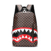 A brown and black checkered plaid laptop backpack with a red and white tooth pattern design.