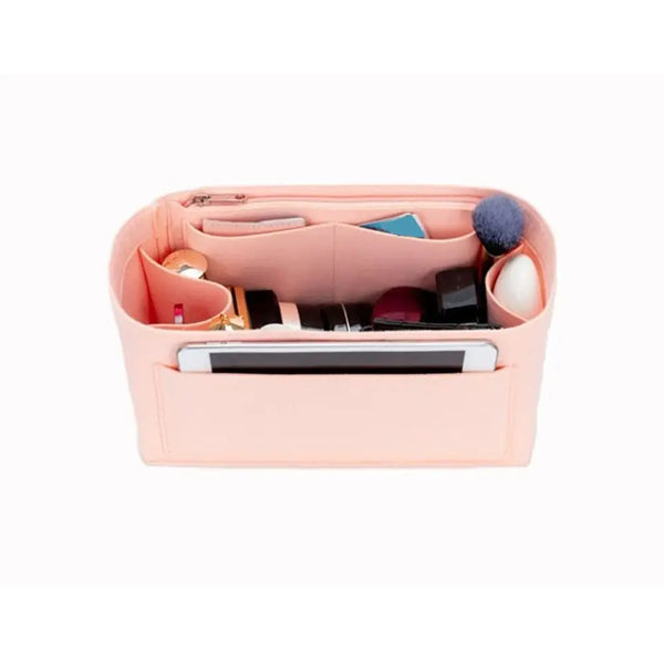 A pink felt liner organizer designed to hold makeup and accessories for handbags.