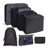 A set of black fabric storage organizers and a mesh pouch for organizing items.