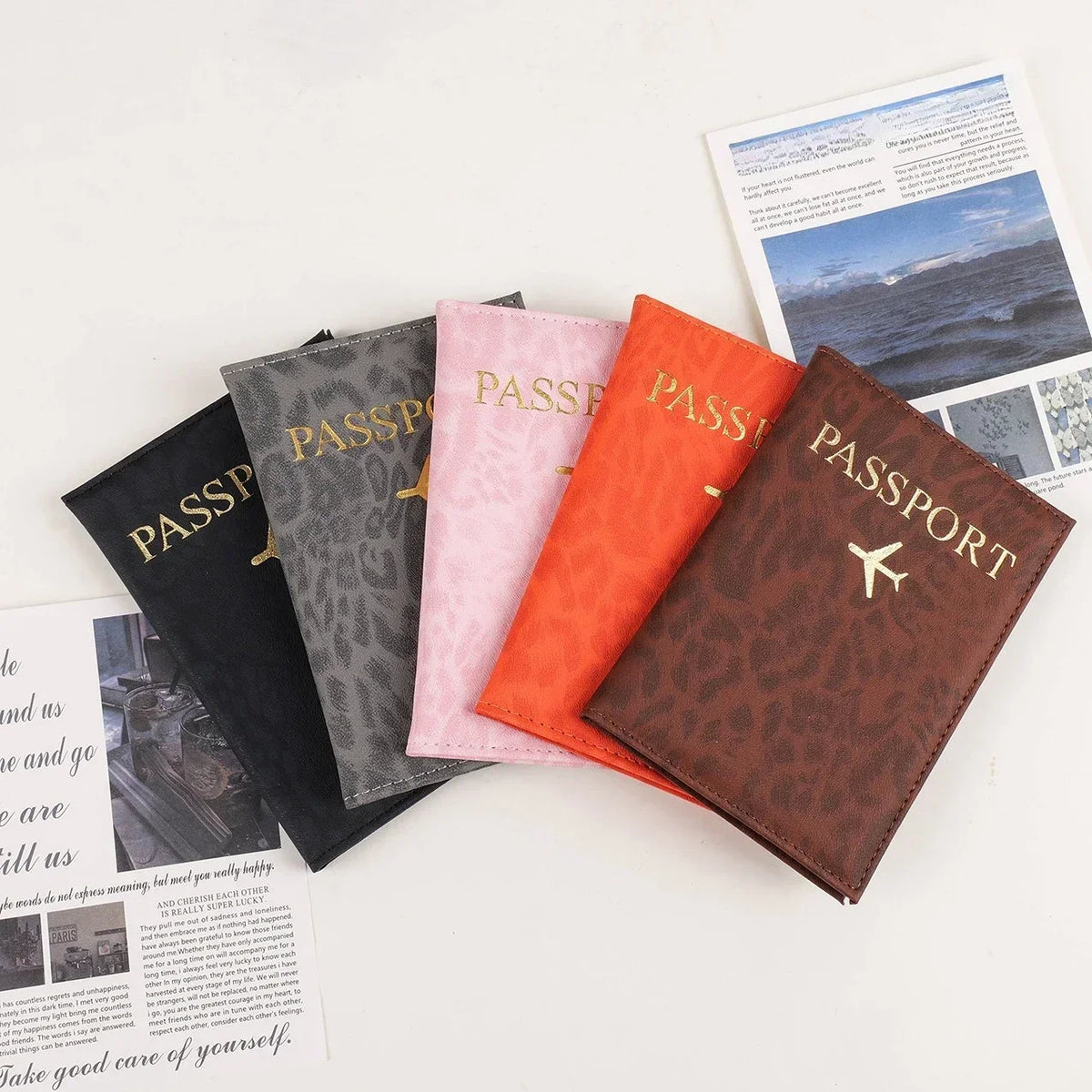 A brown leopard print PU leather passport holder next to a pink and orange passport holder.