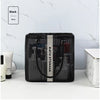 Black mesh drainage shower tote with a handle displayed on a white surface.