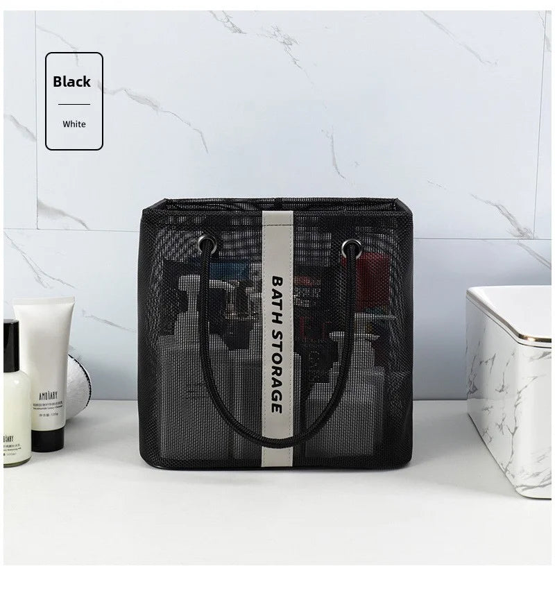 Black mesh drainage shower tote with a handle displayed on a white surface.