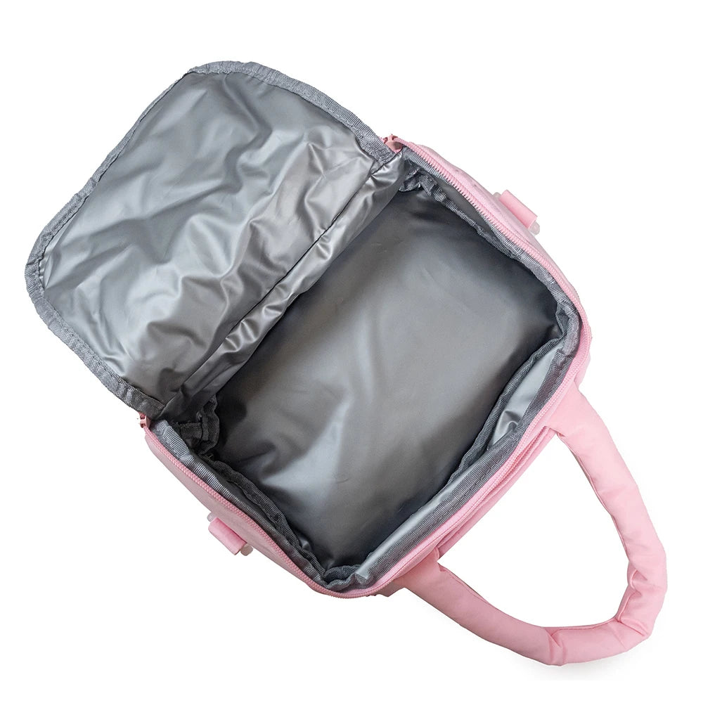 Pink insulated quilted lunch bag with a silver lining and pink strap, shown open.