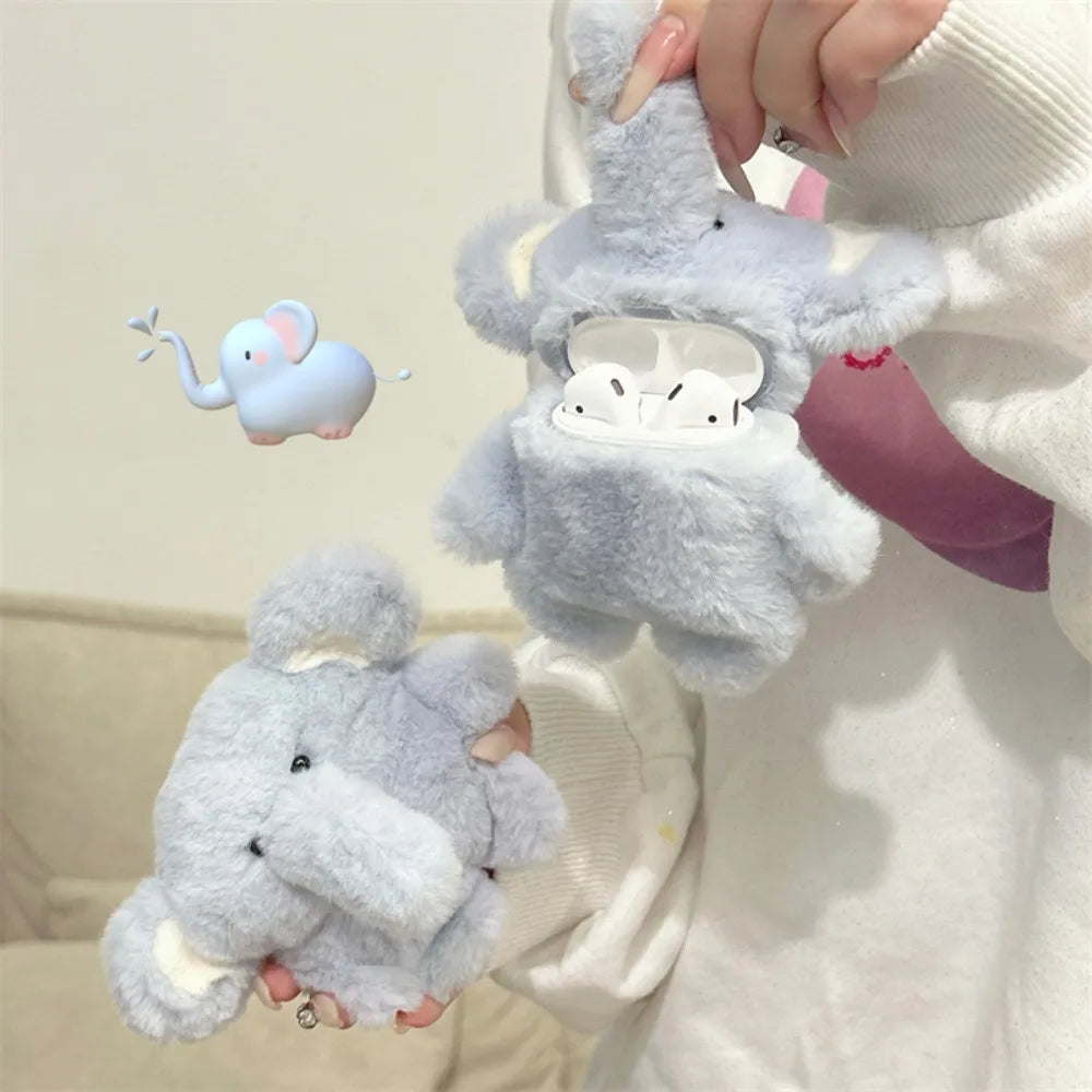 A light gray plush elephant case designed to hold AirPods is being held by a person.