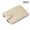 A beige genuine leather slim card holder with a black lining and a silver snap closure.