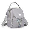 Sac bandoulière floral gris et durable avec fermeture éclair et sangle réglable.