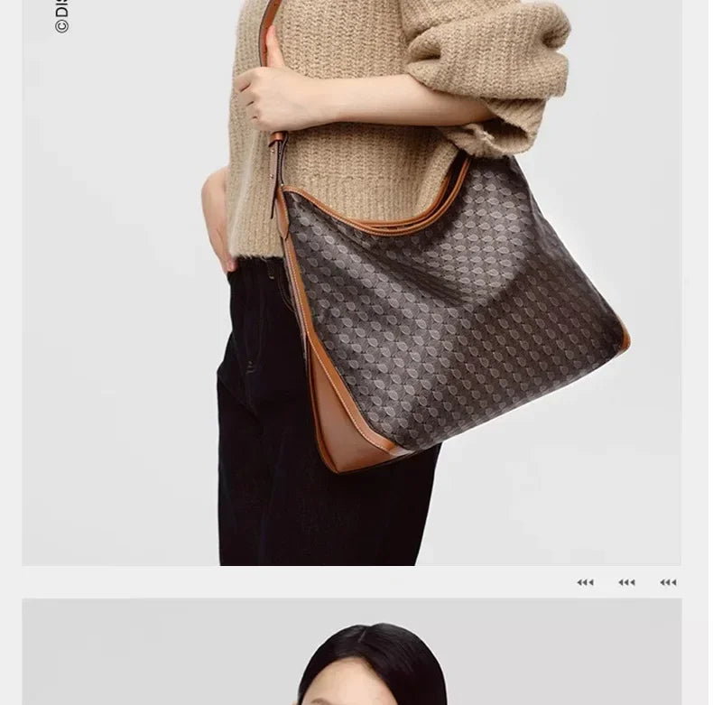 A woman is holding a brown leather geometric embroidery hobo shoulder bag against a light beige sweater and black pants.