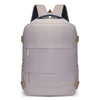 A light gray compact travel backpack with black straps and tan accents.