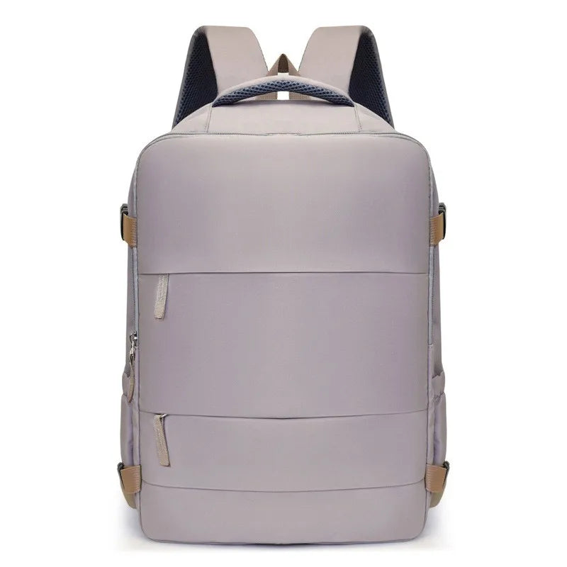 A light gray compact travel backpack with black straps and tan accents.