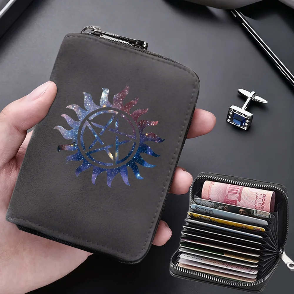 A dark gray compact RFID-blocking card wallet with a sun design is held in a hand next to another small wallet.
