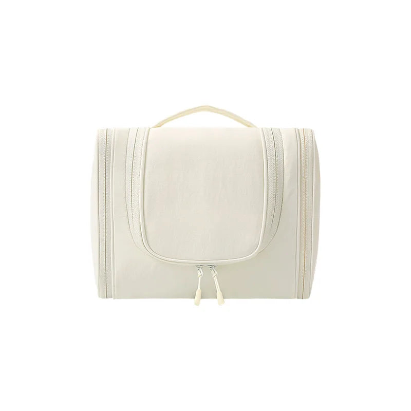 A cream-colored waterproof hanging toiletry bag with a light beige strap and zipper.