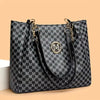 A black and white geometric monogram print tote bag with gold hardware shown against a light background.