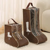 A brown portable waterproof boot storage bag with a dark lining is shown on a light rug.
