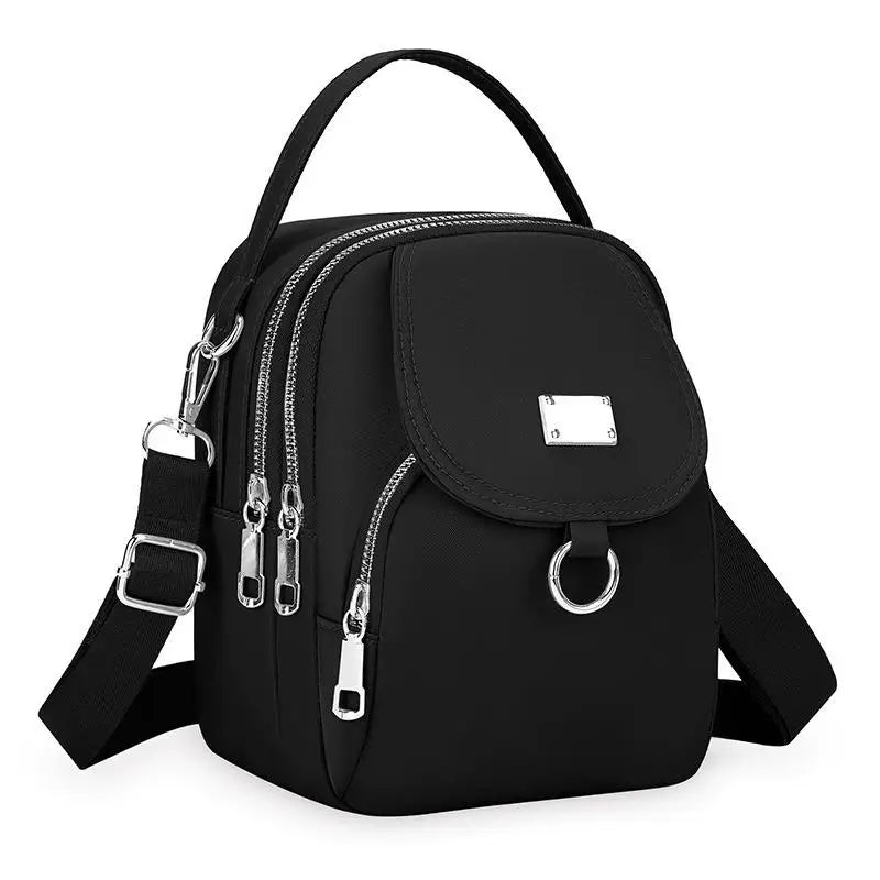 Sac bandoulière floral noir durable avec fermeture éclair et sangle réglable.
