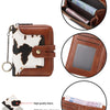 A brown leather bifold wallet with a white cow print cover and RFID blocking material.