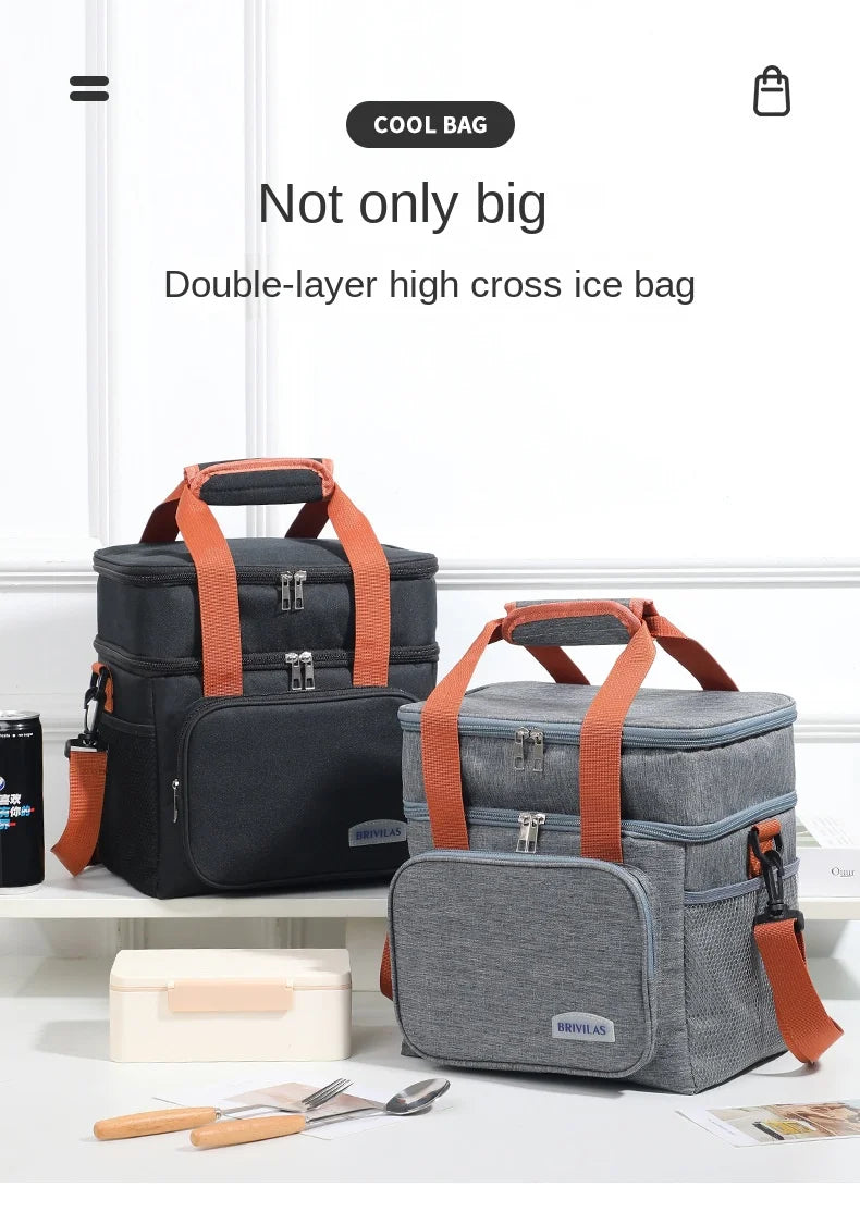 Un paire de sacs à glace doubles en noir et gris avec des sangles orange, exposés sur une surface blanche.