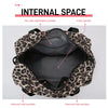 Internal view of a leopard print travel duffel bag showing various pockets including a dry wet separation pocket and main poc