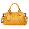 A mustard yellow soft leather tote bag with a top handle and adjustable shoulder strap.