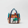A women's cow print fashion backpack in white and blue fabric.