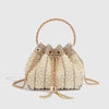 A cream-colored evening clutch embellished with small pearls and gold chain detailing.