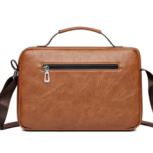 A brown faux leather crossbody bag with a zipper closure and a leather strap is shown against a white background.
