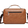 A brown faux leather crossbody bag with a zipper closure and a leather strap is shown against a white background.