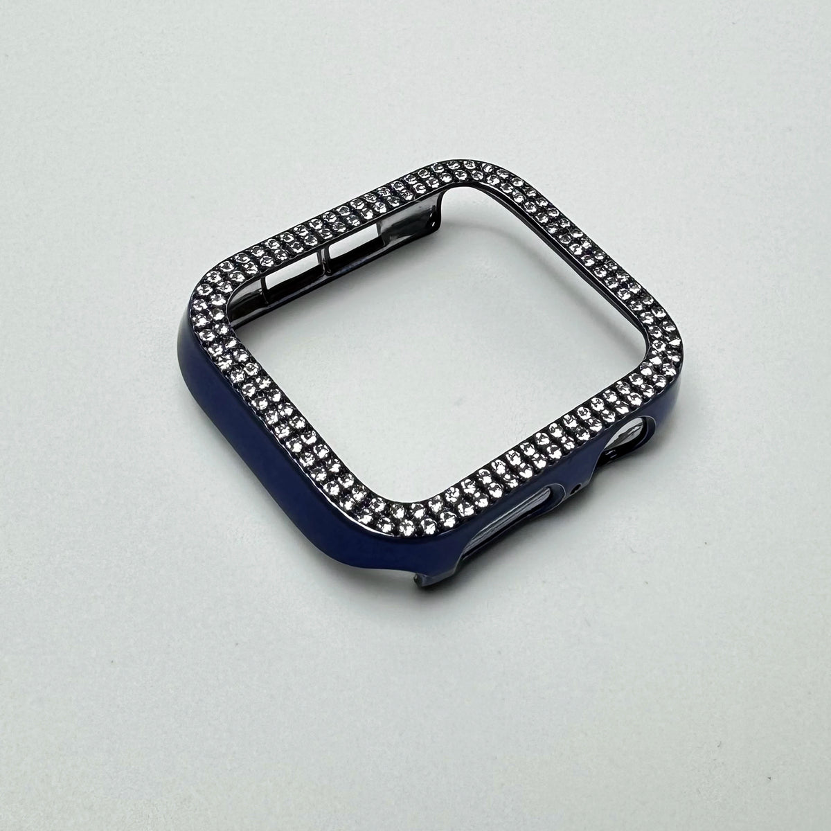 A dark blue glitter diamond rhinestone bumper case for an Apple Watch displayed on a white background.
