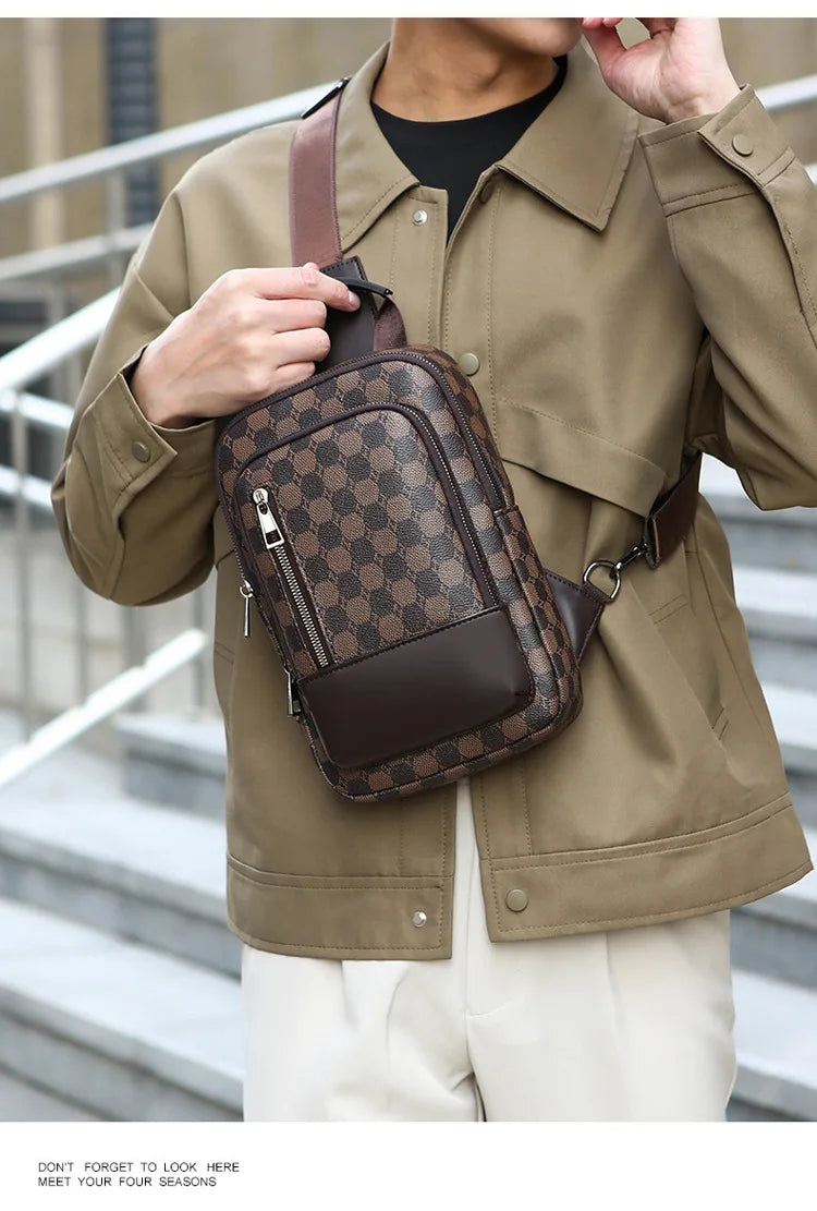 A man wearing a tan jacket holds a brown geometric pattern crossbody bag.